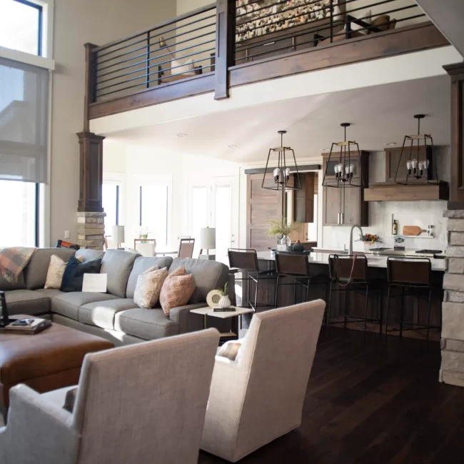 Comfortable living room seating area with modern furnishings and kitchen